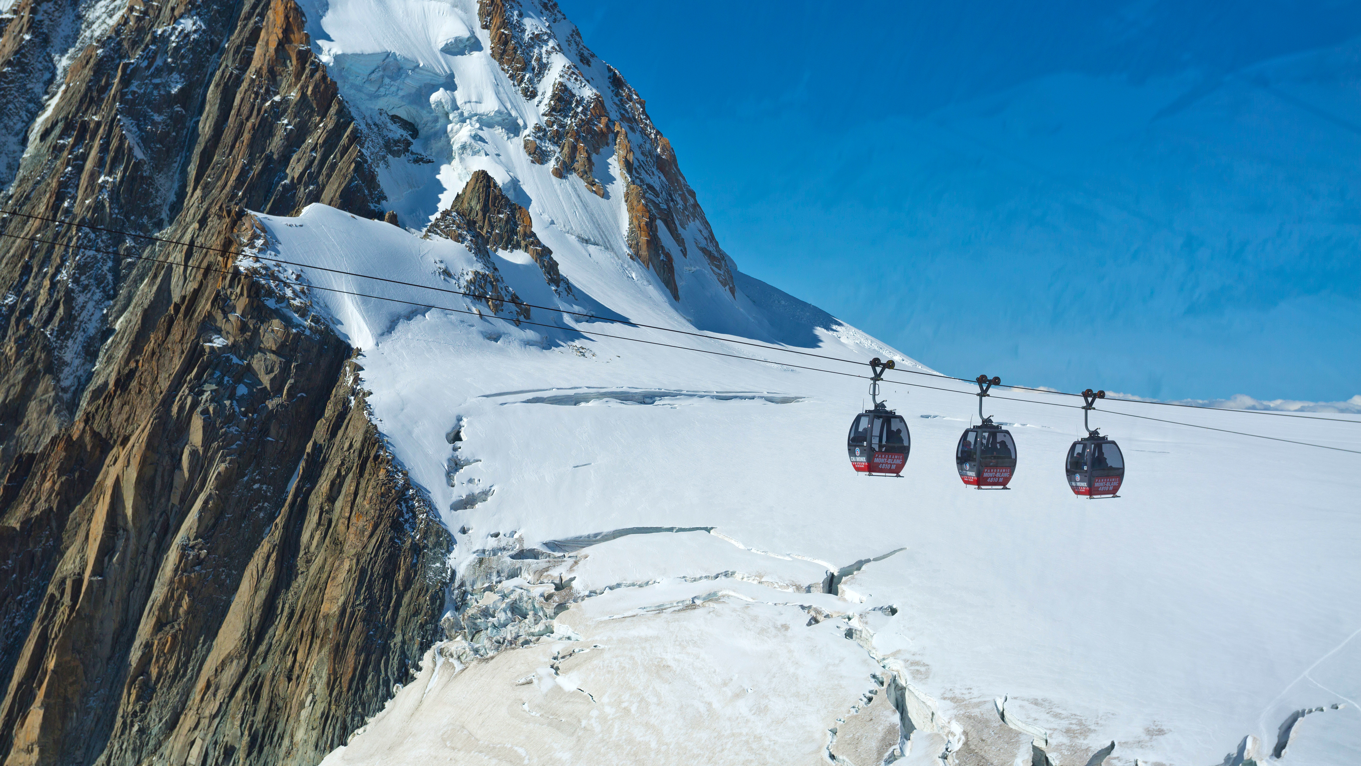 Gondolas dangling over a glacier near France's Mont Blanc.